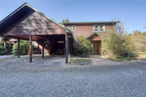 a view of a house with backyard porch and sitting area