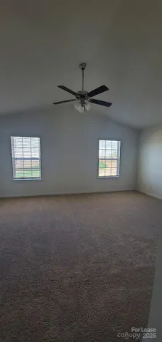 a view of a livingroom with a ceiling fan and window