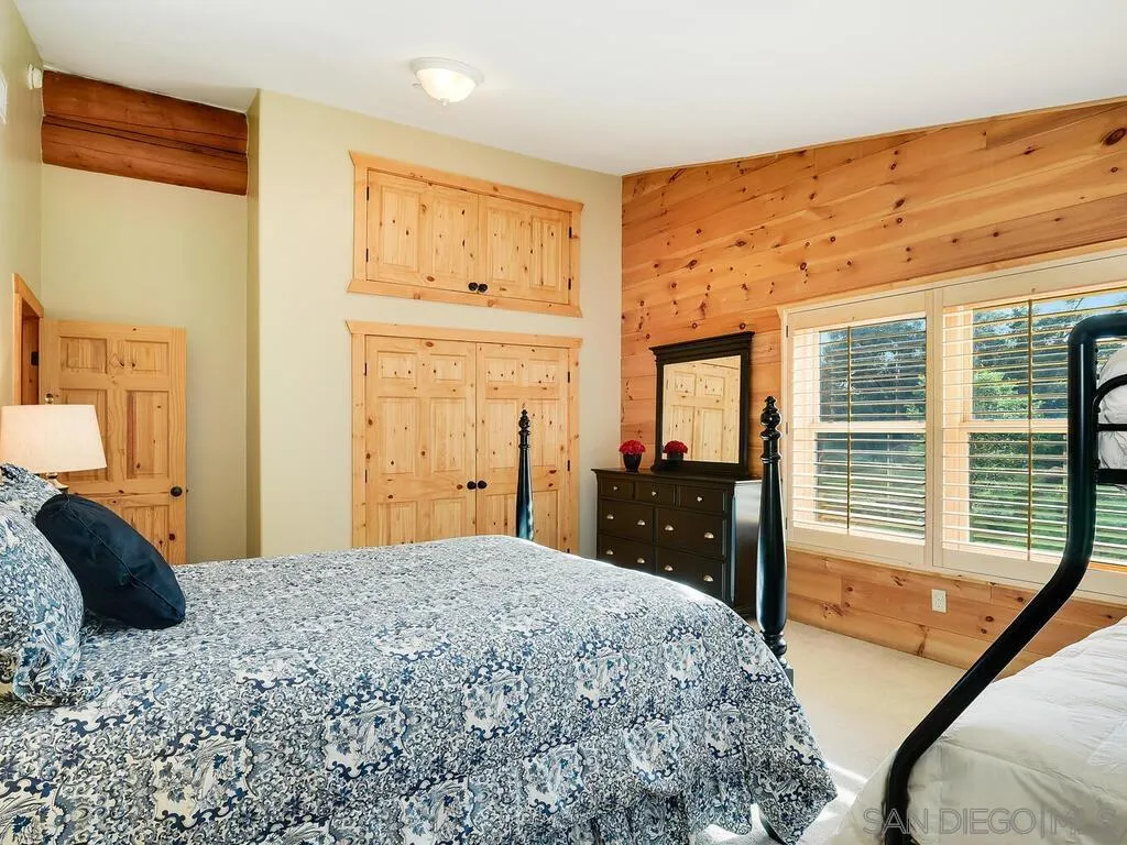 1068 West Incense Cedar Road Julian, CA 92036 - Photo 39 of 63 a bedroom with a bed and dresser with mirror