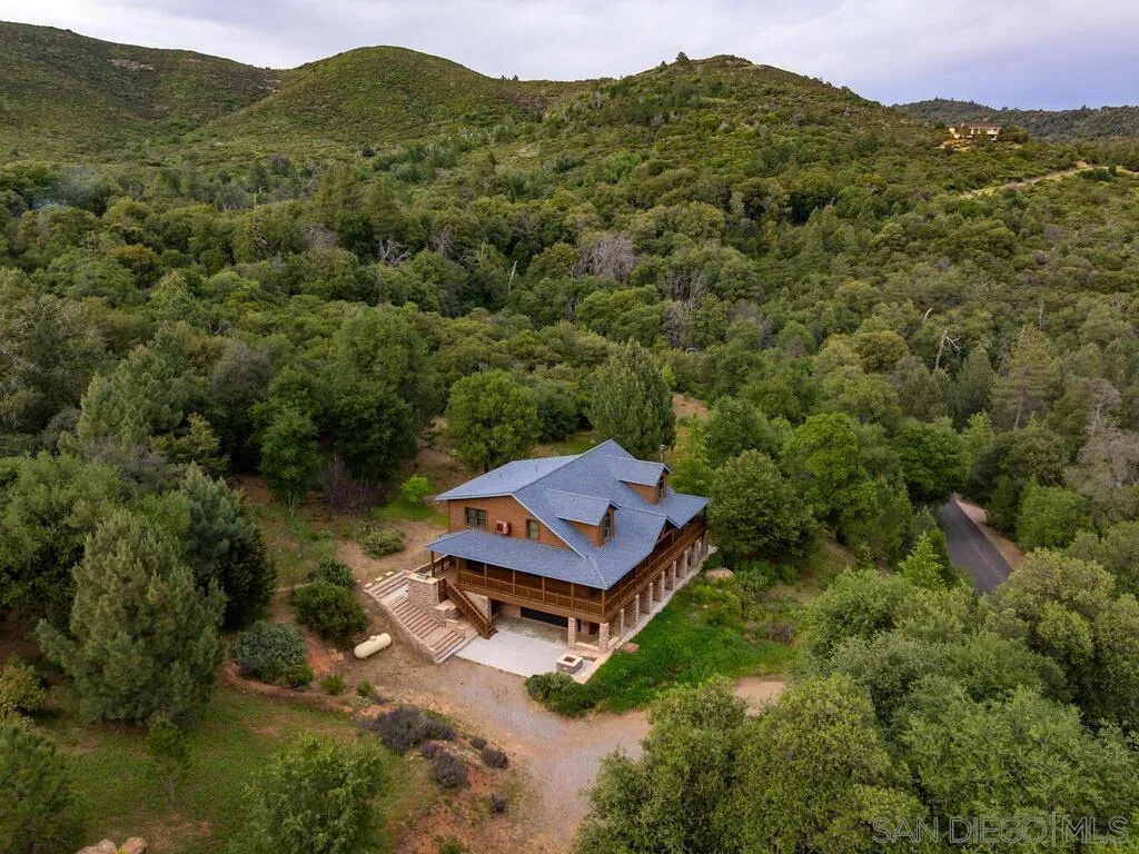 1068 West Incense Cedar Road Julian, CA 92036 - Photo 57 of 63 a view of a lush green forest with a house