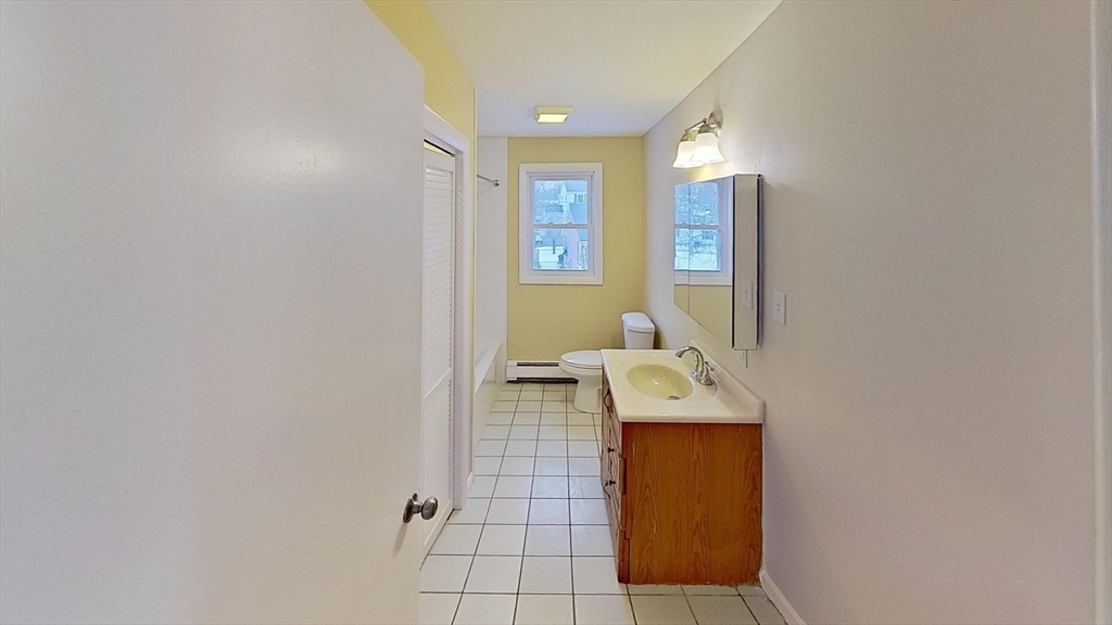 52 Rockefeller Street, Unit 2 Randolph, MA 02368 - Photo 4 of 9 a bathroom with a sink and a mirror
