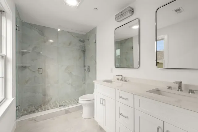 a bathroom with a double vanity sink mirror double shower and a bathtub