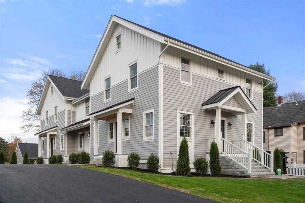 63 Oak Street, Unit B Wellesley, MA 02482 - Photo 25 of 26 a view of a white house next to a yard and road