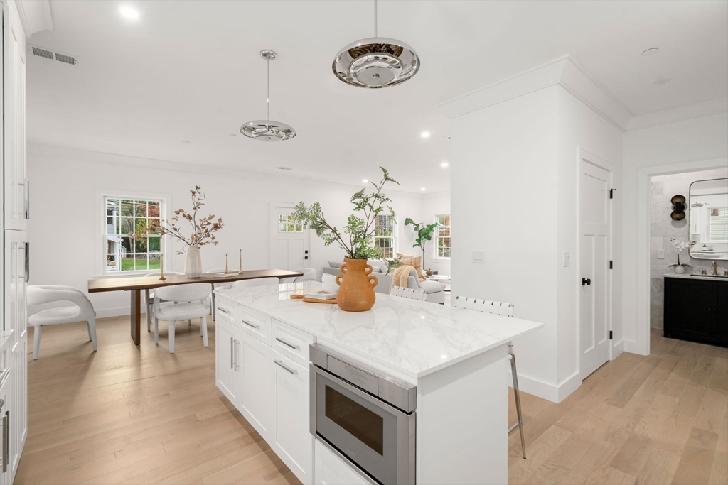 63 Oak Street, Unit B Wellesley, MA 02482 - Photo 6 of 26 a kitchen with a sink stove and cabinets