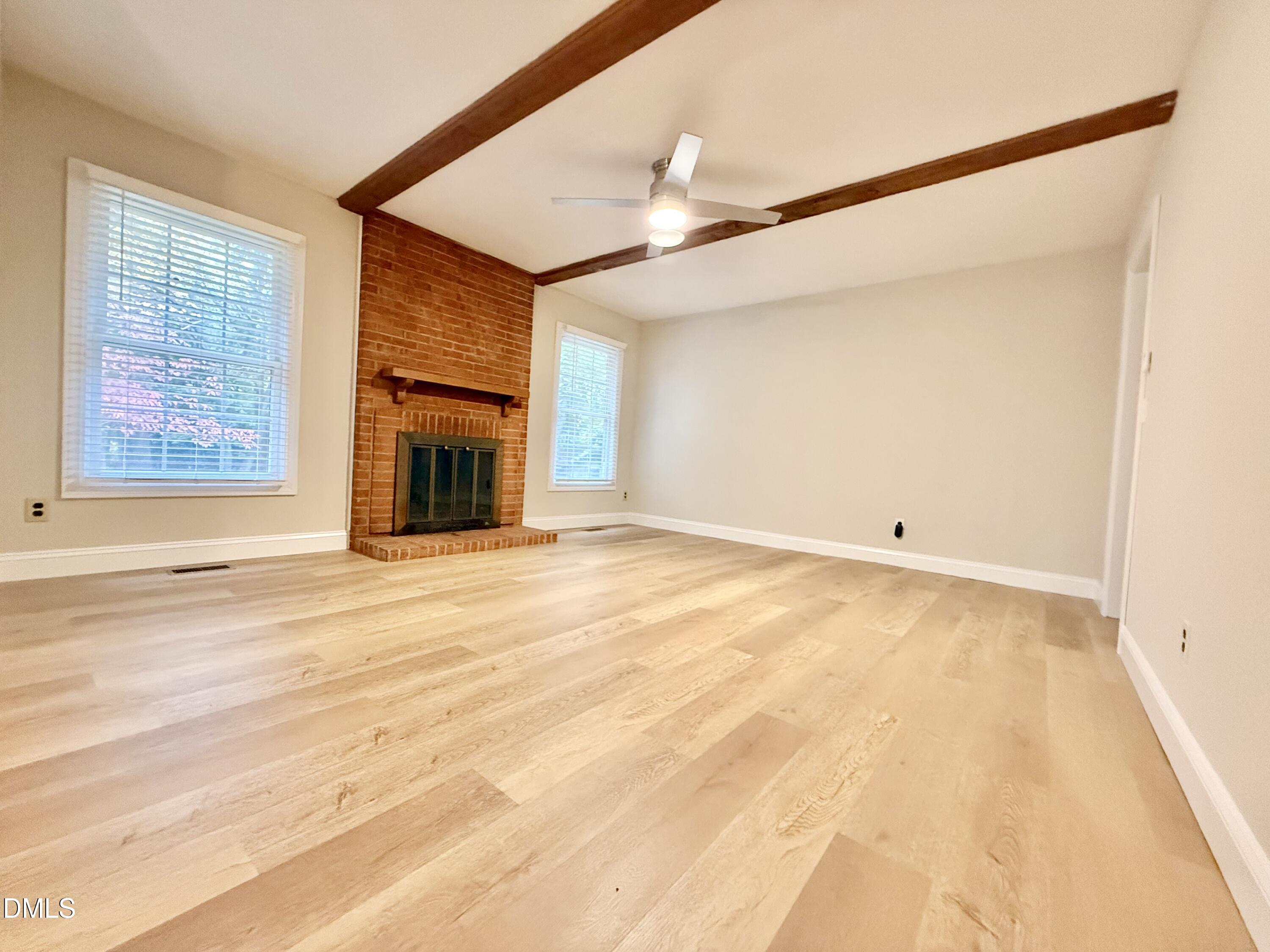 3517 Morningside Drive Raleigh, NC 27607 - Photo 4 of 14 an empty room with fireplace and windows