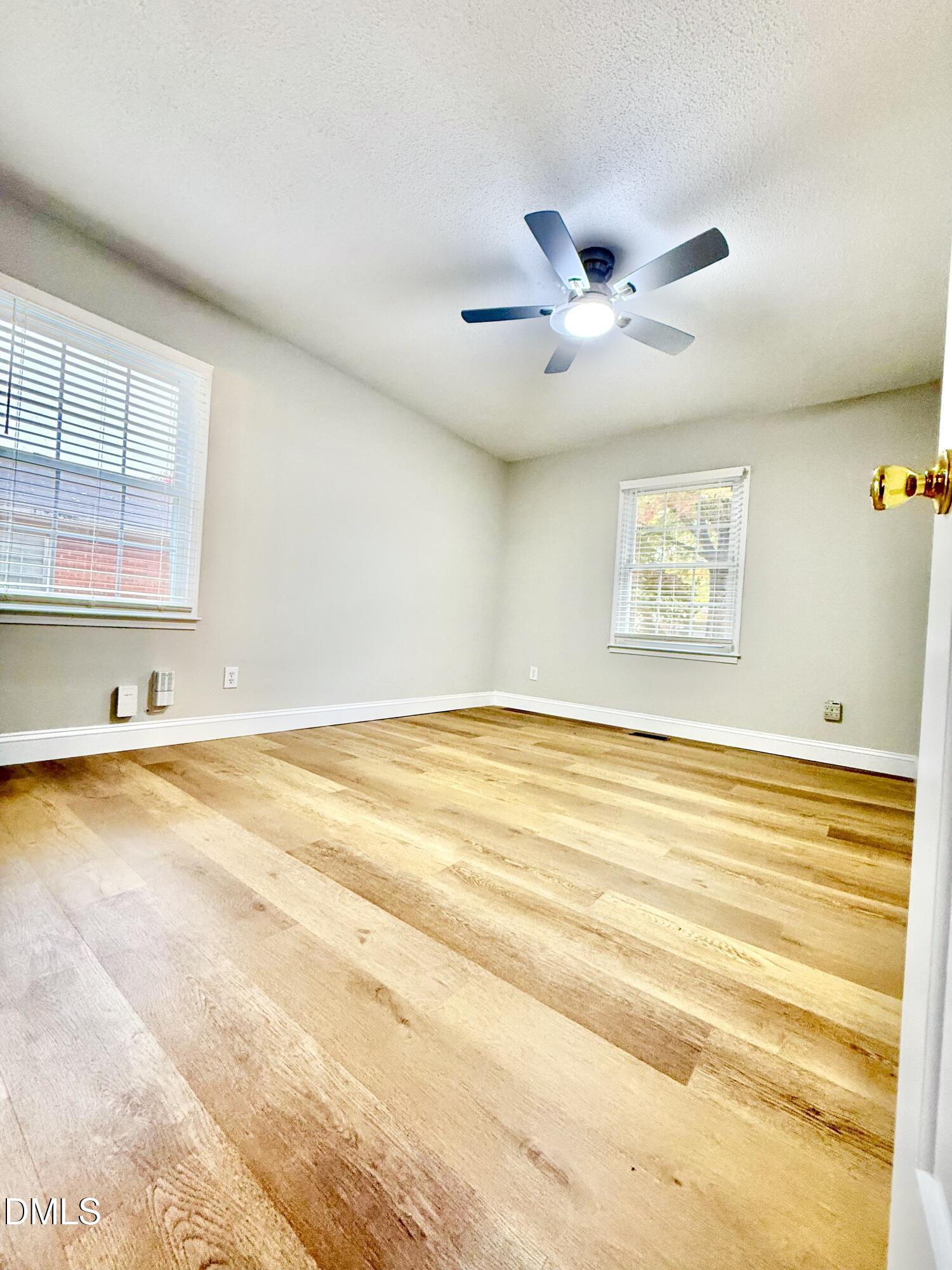 3517 Morningside Drive Raleigh, NC 27607 - Photo 8 of 14 a view of an empty room with window and a ceiling fan