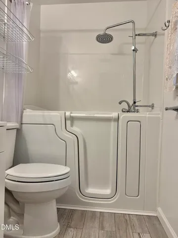 a bathroom with a toilet and a shower