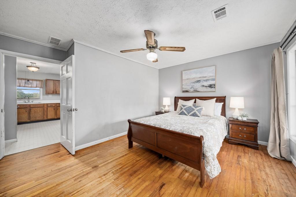 16685 Hopewell Road Milton, GA 30004 - Photo 20 of 64 a bedroom with a bed and wooden floor
