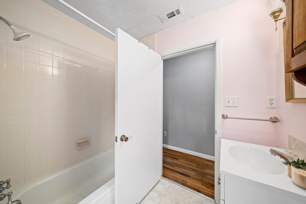 16685 Hopewell Road Milton, GA 30004 - Photo 28 of 64 a bathroom with a bathtub and a shower