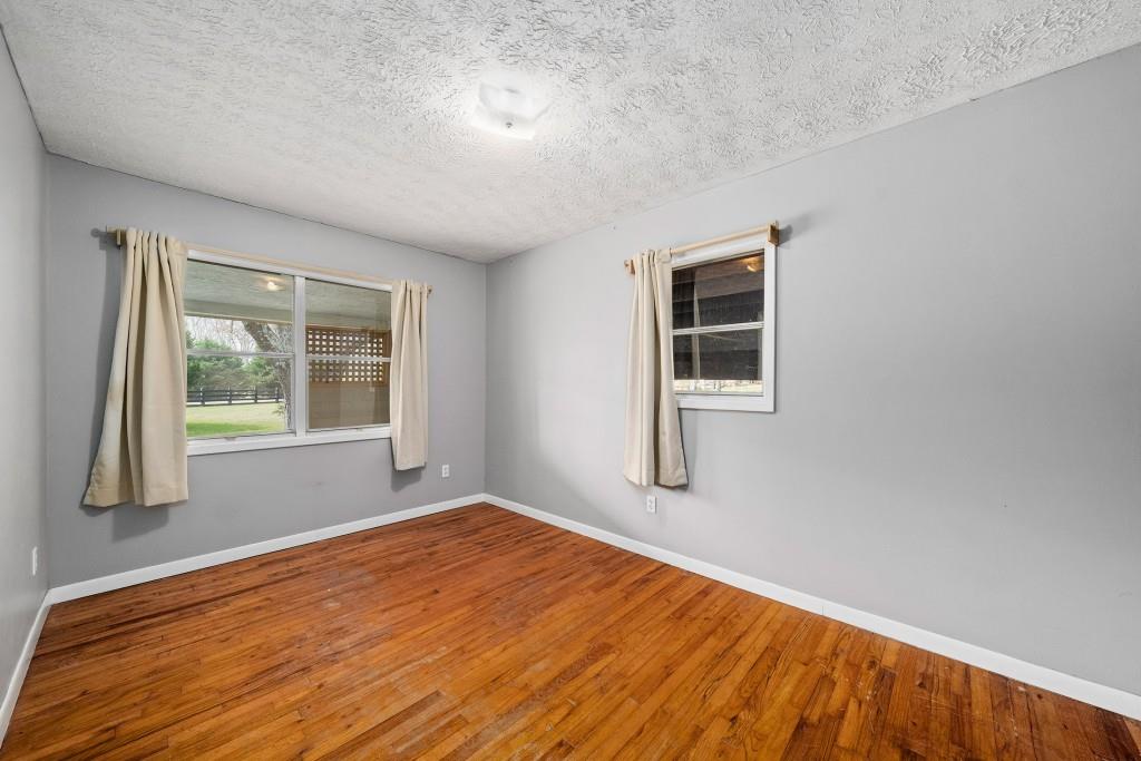 16685 Hopewell Road Milton, GA 30004 - Photo 29 of 64 an empty room with wooden floor and windows