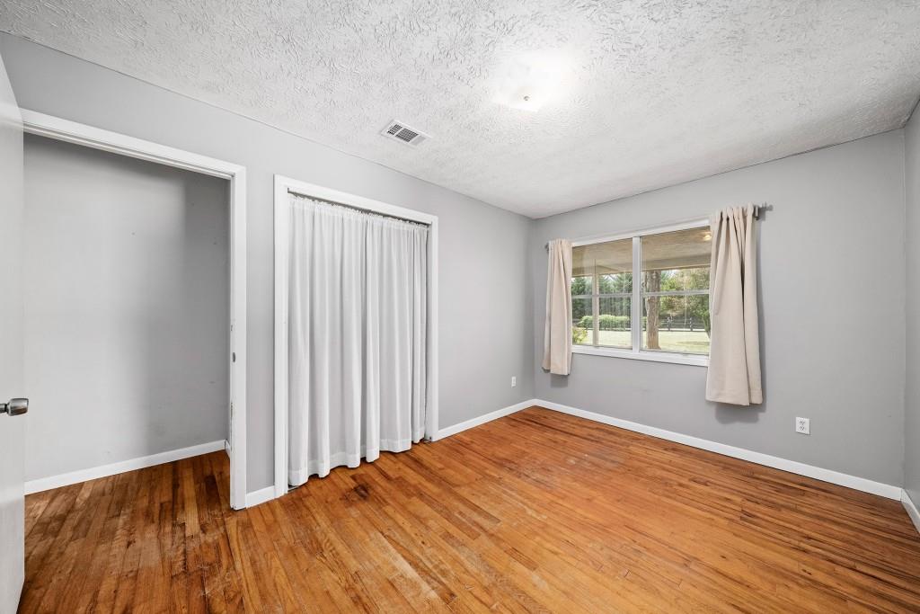16685 Hopewell Road Milton, GA 30004 - Photo 30 of 64 an empty room with wooden floor and windows