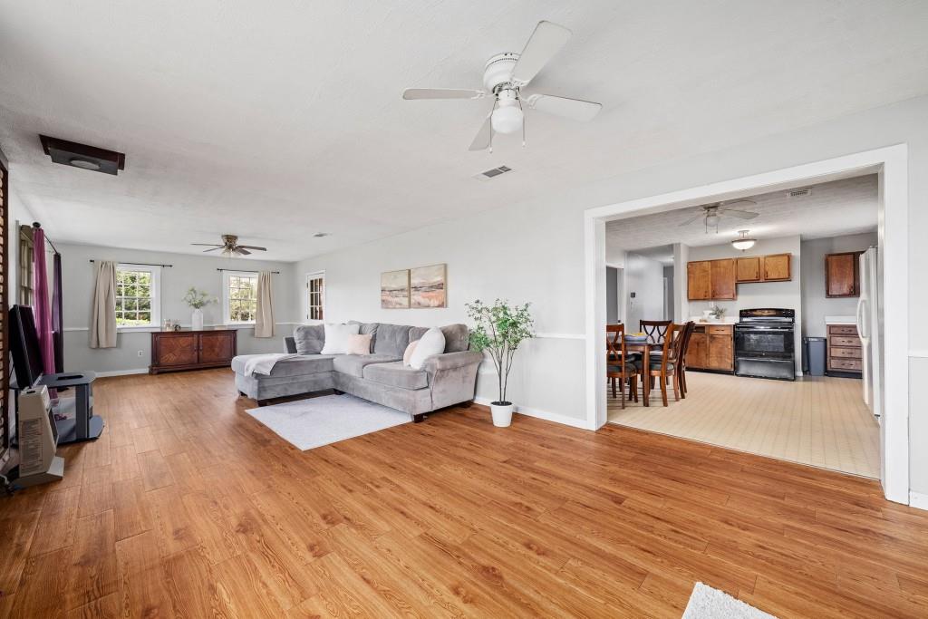 16685 Hopewell Road Milton, GA 30004 - Photo 10 of 64 a living room with furniture and wooden floor