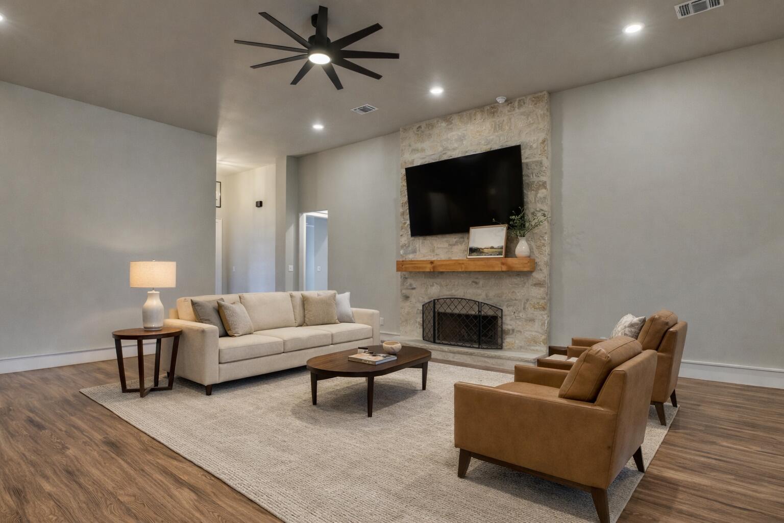 5303 110th Street Lubbock, TX 79424 - Photo 12 of 55 a living room with furniture a fireplace and a flat screen tv