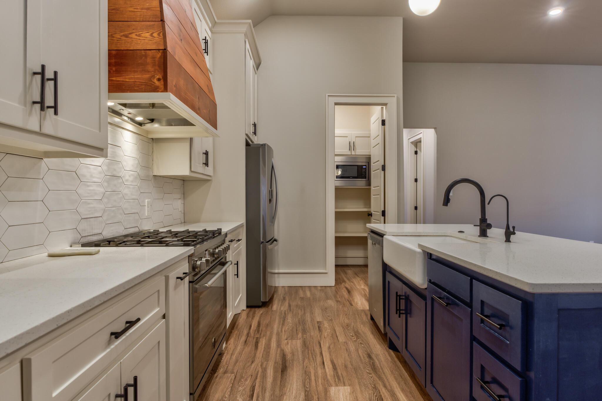 5303 110th Street Lubbock, TX 79424 - Photo 21 of 55 a kitchen with stainless steel appliances a sink stove and cabinets