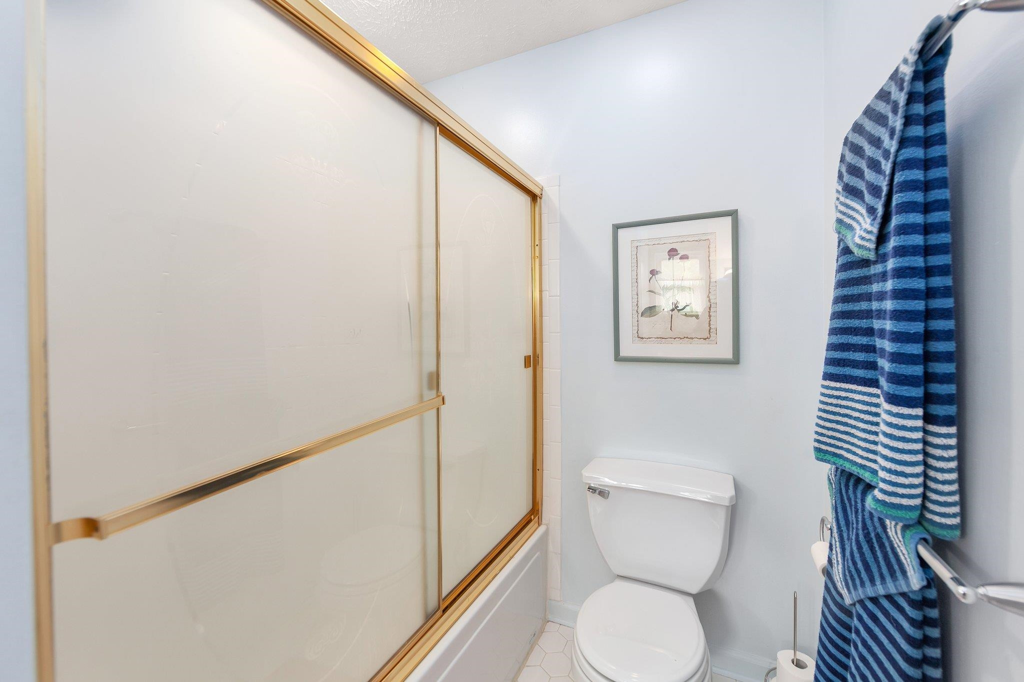 65 Jennalee Lane Medon, TN 38356 - Photo 19 of 43 a white toilet sitting next to a shower curtain