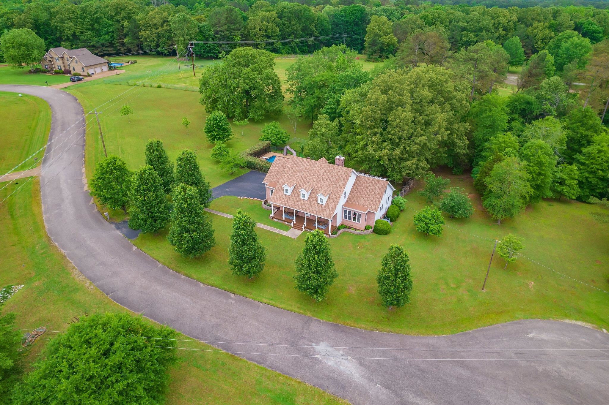 65 Jennalee Lane Medon, TN 38356 - Photo 2 of 43 an aerial view of a house with a swimming pool