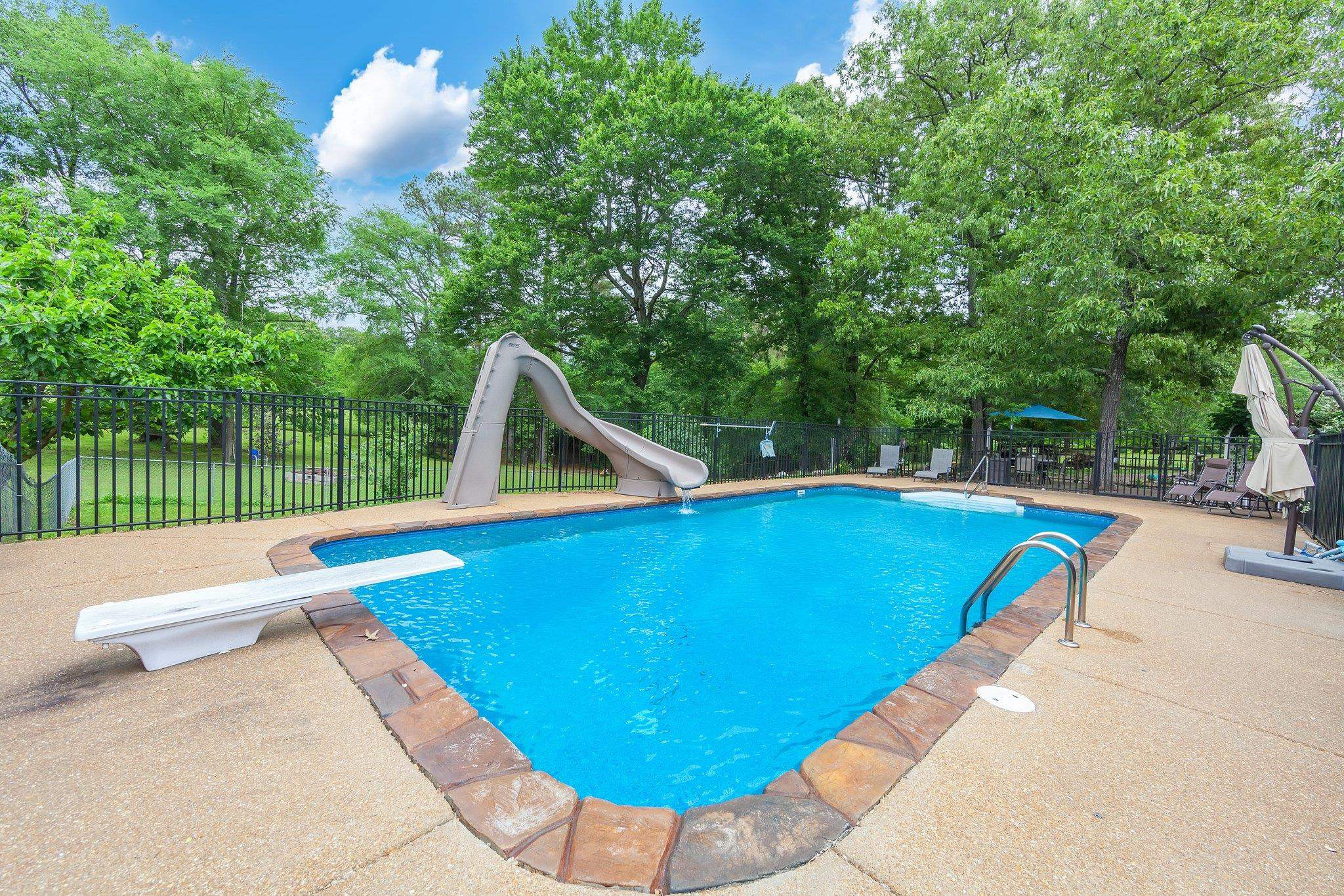 65 Jennalee Lane Medon, TN 38356 - Photo 4 of 43 a view of a swimming pool with a lounge chairs and a small yard