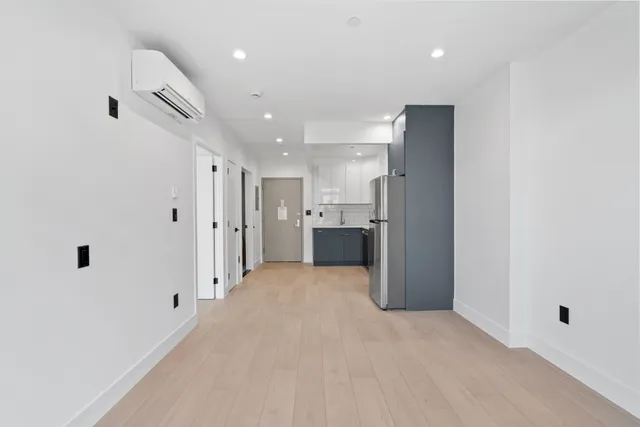 a view of a kitchen with a refrigerator and a sink