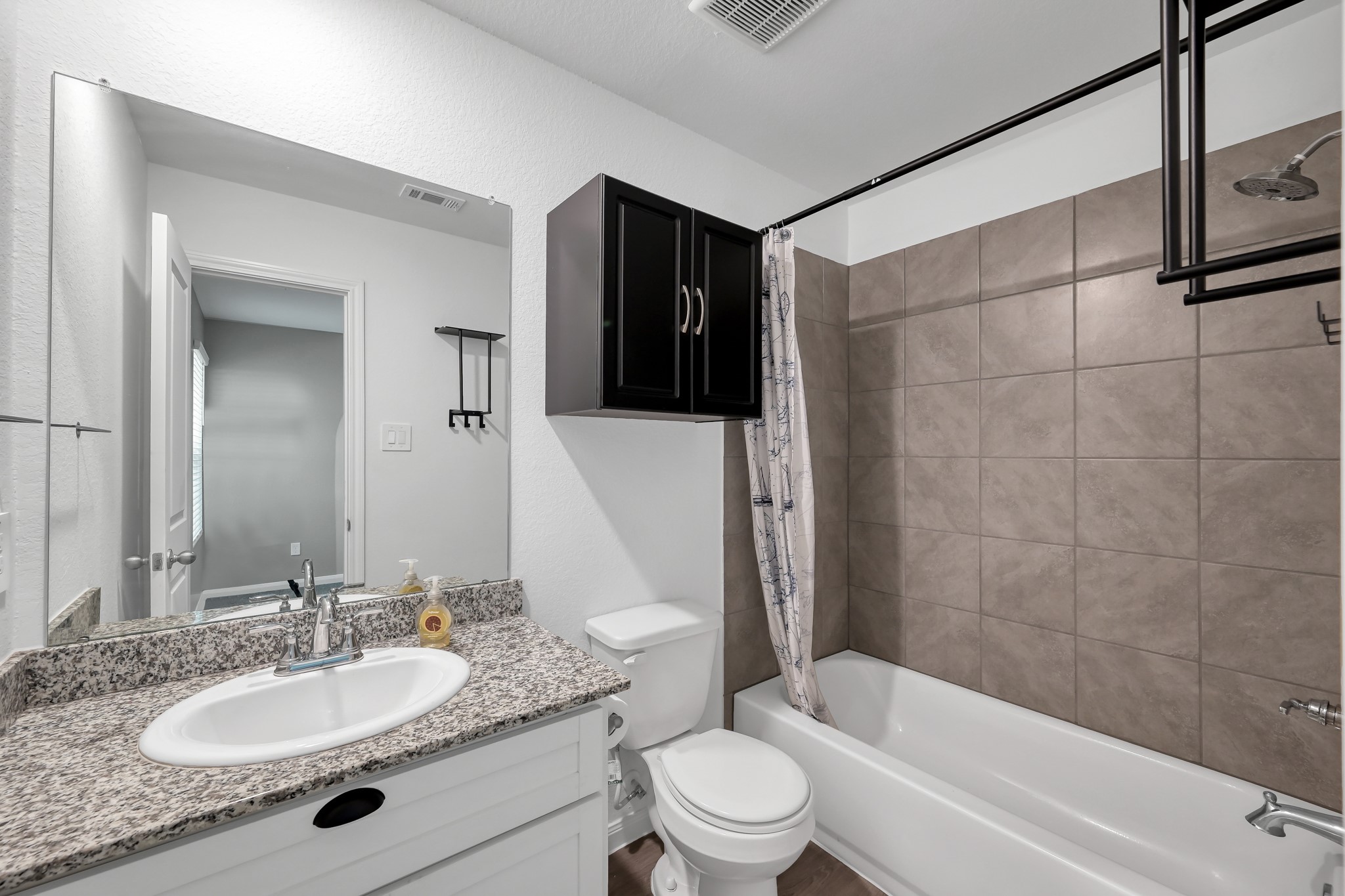 16399 Jasmine Marie Place Conroe, TX 77306 - Photo 12 of 22 a bathroom with a granite countertop sink toilet and shower