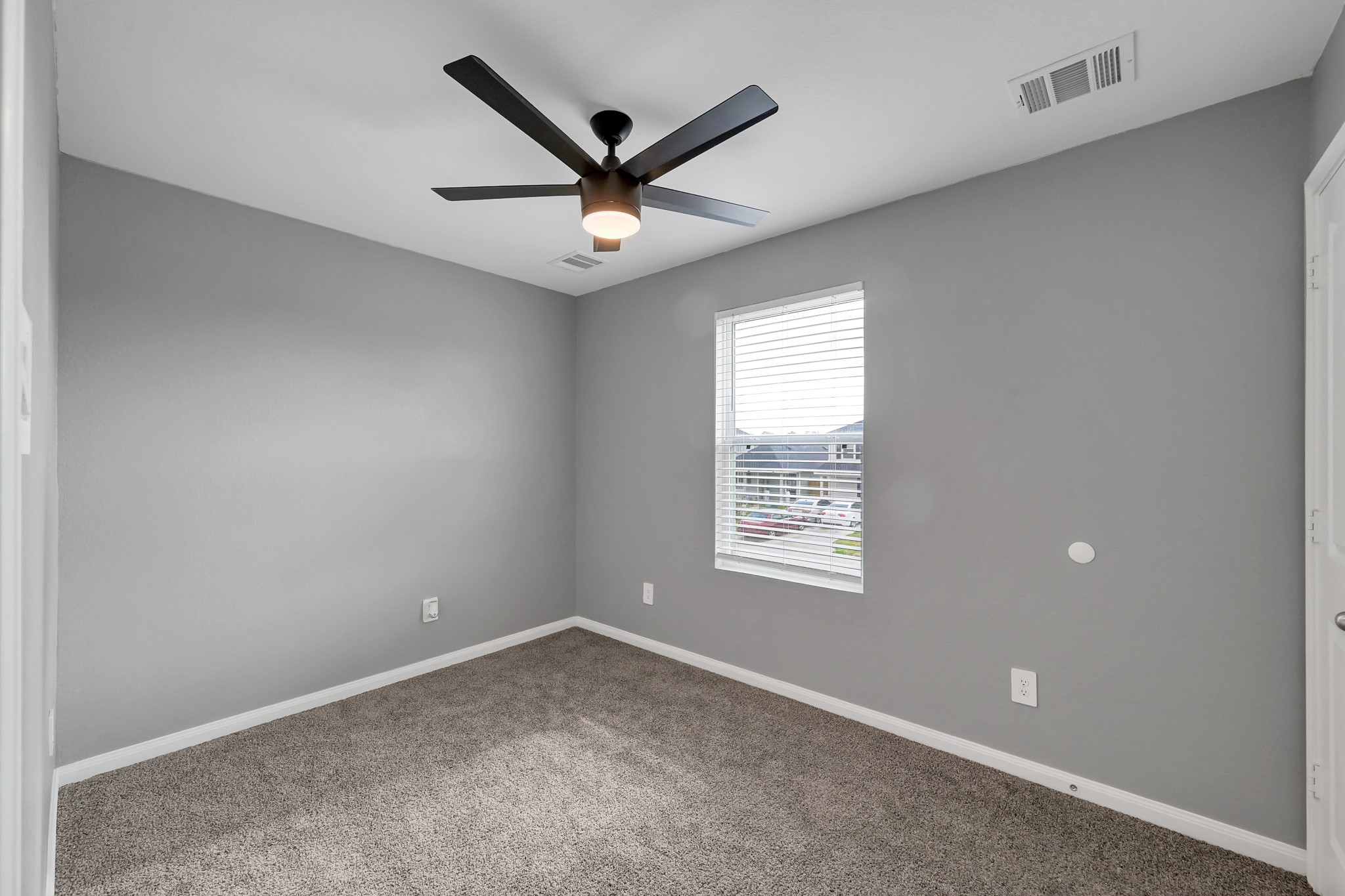 16399 Jasmine Marie Place Conroe, TX 77306 - Photo 14 of 22 an empty room with a window and a fan