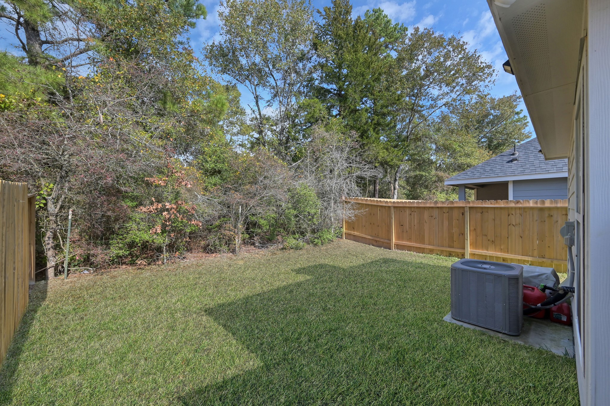 16399 Jasmine Marie Place Conroe, TX 77306 - Photo 17 of 22 a view of backyard with tub and trees
