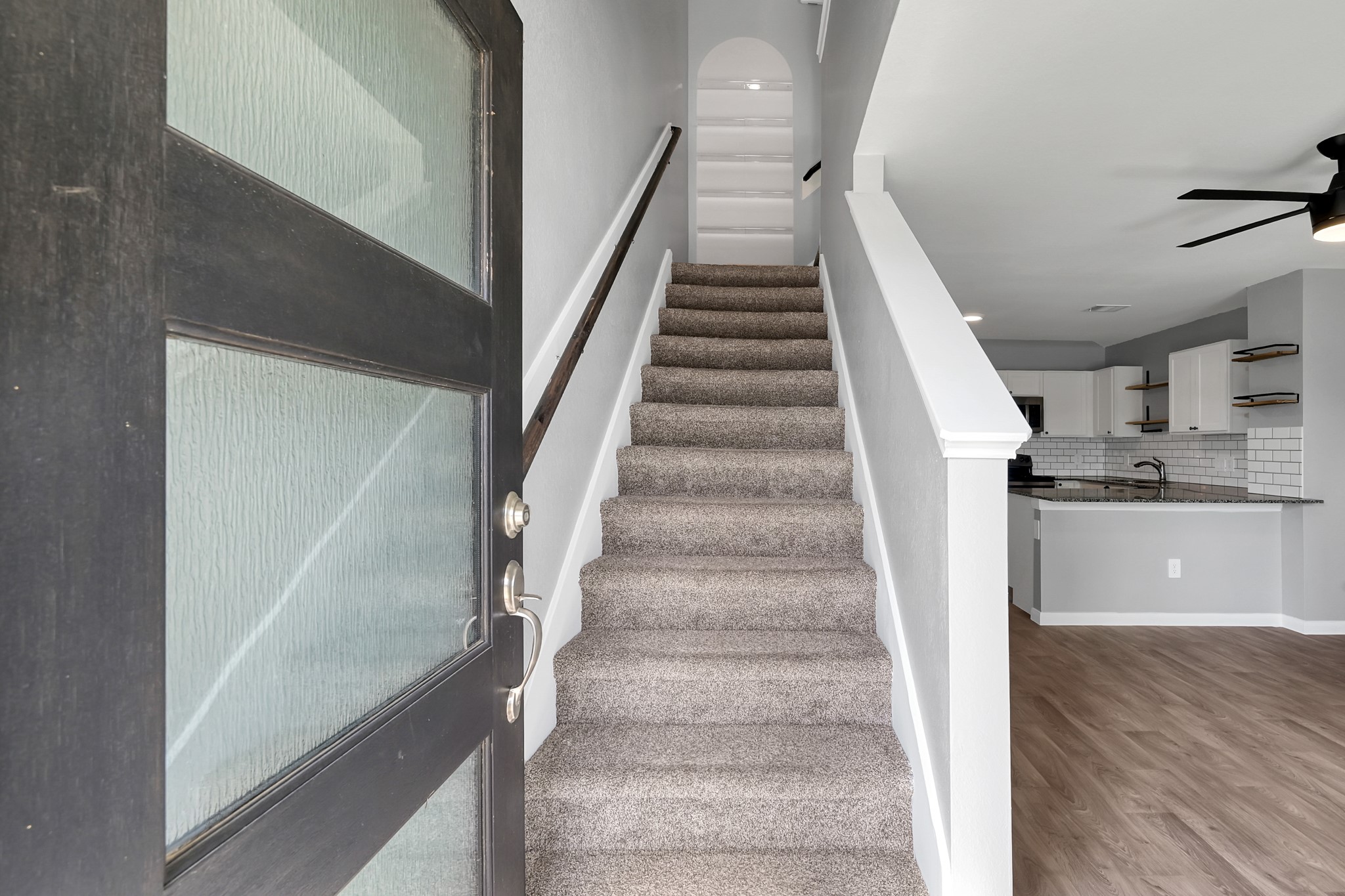 16399 Jasmine Marie Place Conroe, TX 77306 - Photo 4 of 22 a view of staircase with white walls and railing