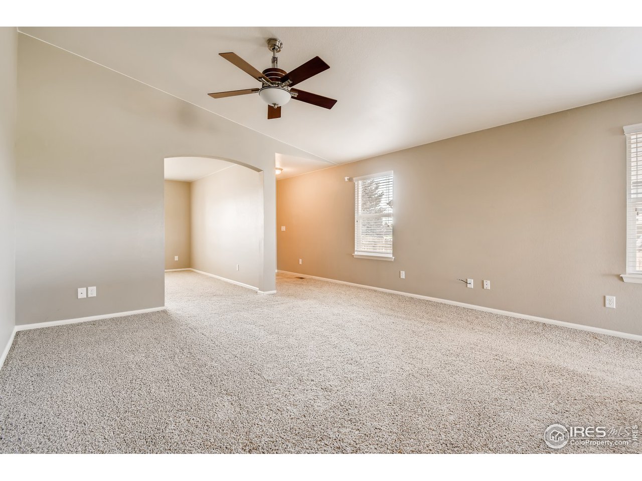 8663 Raspberry Drive Frederick, CO 80504 - Photo 14 of 33 a view of a livingroom with a ceiling fan and window