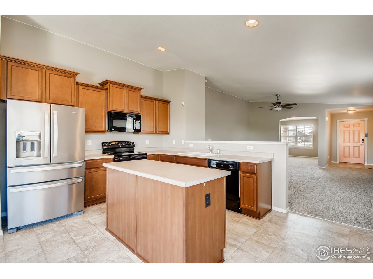 8663 Raspberry Drive Frederick, CO 80504 - Photo 7 of 33 a kitchen with a stove a sink and a refrigerator