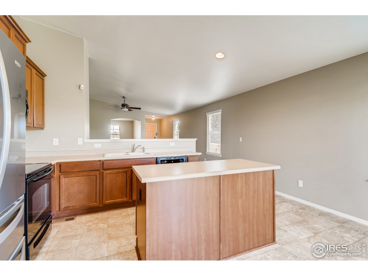 8663 Raspberry Drive Frederick, CO 80504 - Photo 8 of 33 a kitchen with stainless steel appliances granite countertop a sink stove and refrigerator