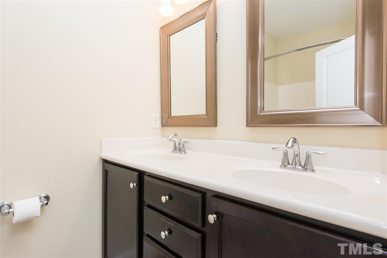 1433 Crafton Way Raleigh, NC 27607 - Photo 13 of 23 a bathroom with a sink and a mirror