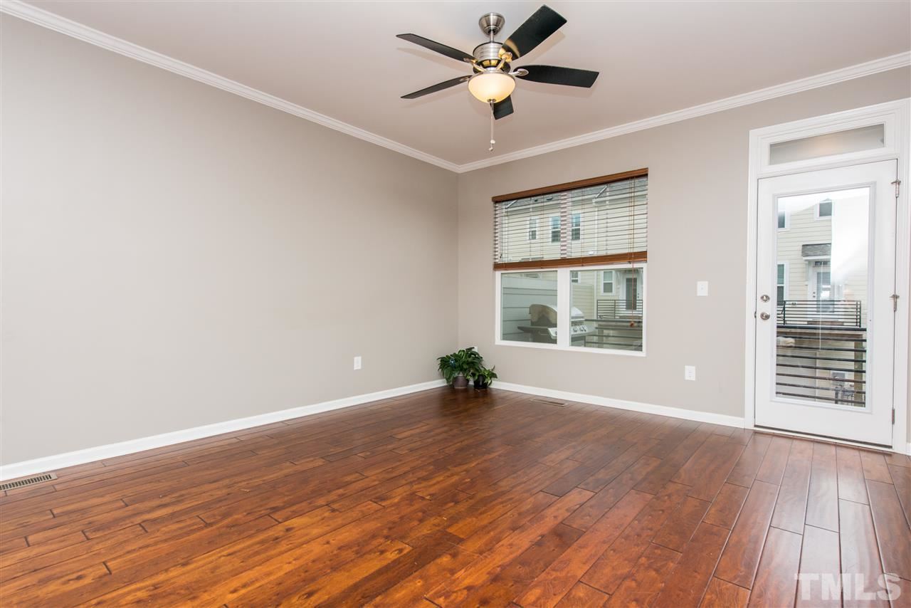 1433 Crafton Way Raleigh, NC 27607 - Photo 3 of 23 a view of an empty room with wooden floor and a window