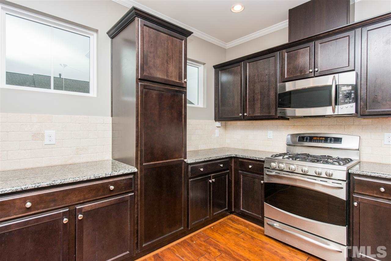 1433 Crafton Way Raleigh, NC 27607 - Photo 8 of 23 a kitchen with a refrigerator stove and microwave