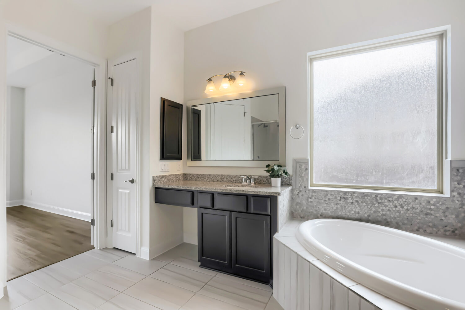 19205 Burrowbridge Road Pflugerville, TX 78660 - Photo 17 of 38 Indulge in relaxation in this luxurious primary bathroom, featuring a deep soaking tub, dual vanities, walk-in shower, and water closet