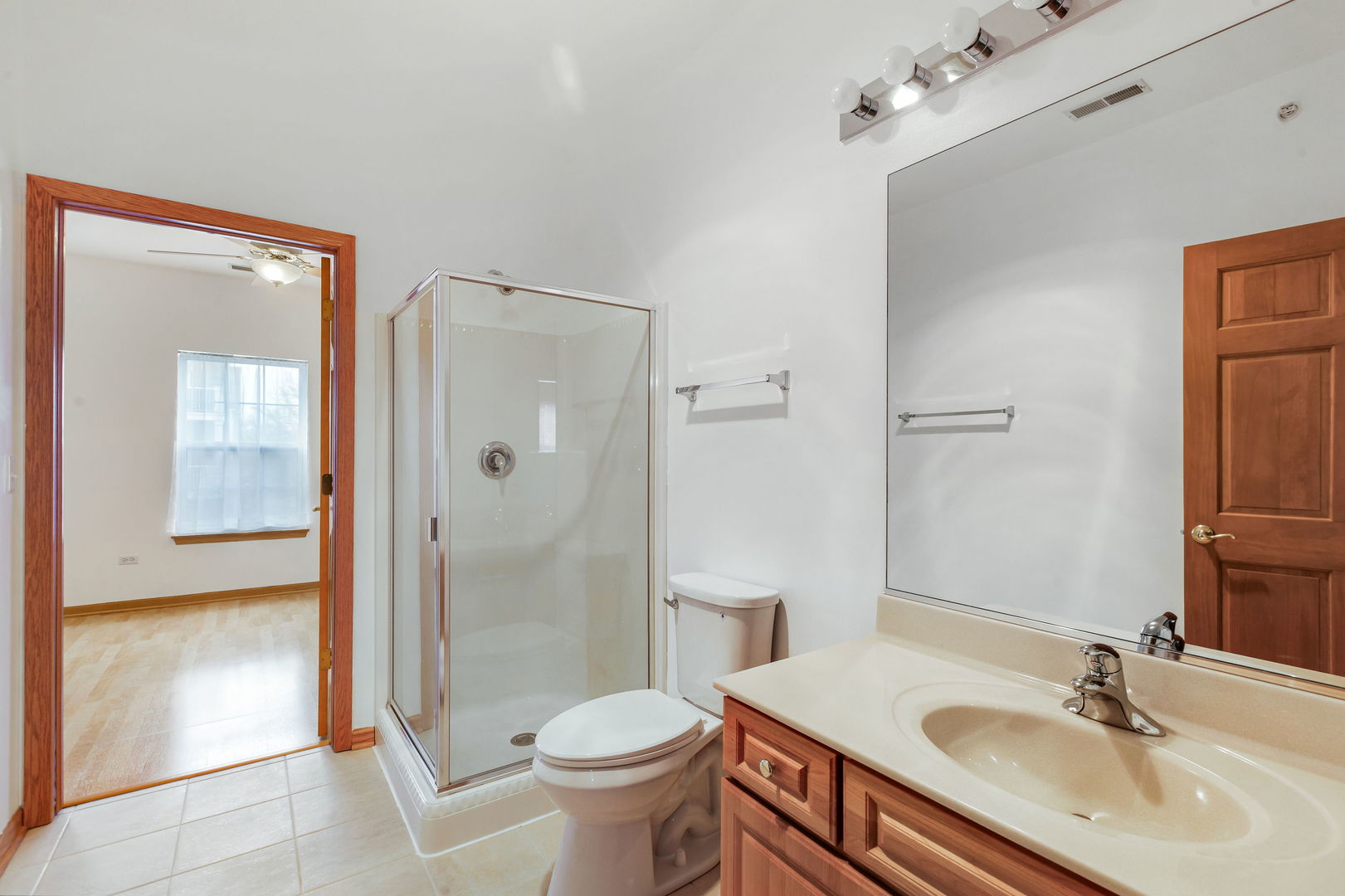 1259 West Lake Street, Unit 203 Addison, IL 60101 - Photo 14 of 17 a bathroom with a sink toilet a mirror and shower