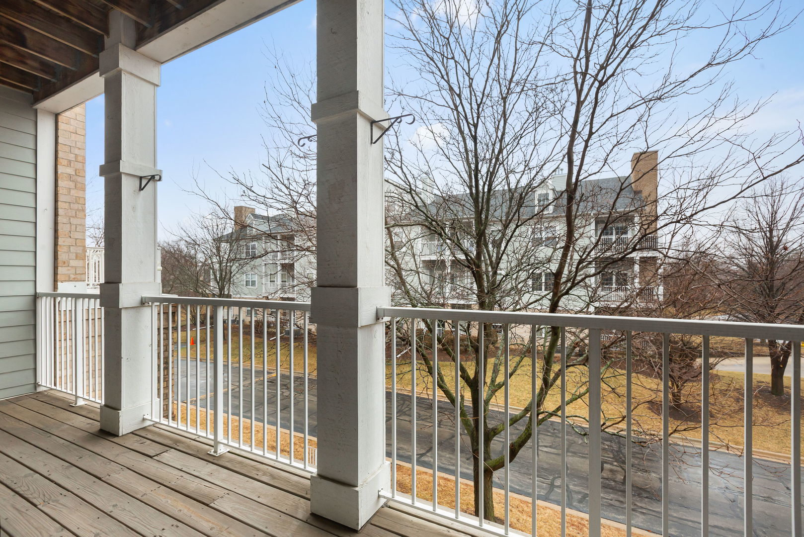 1259 West Lake Street, Unit 203 Addison, IL 60101 - Photo 8 of 17 a view of a balcony with wooden floor and fence