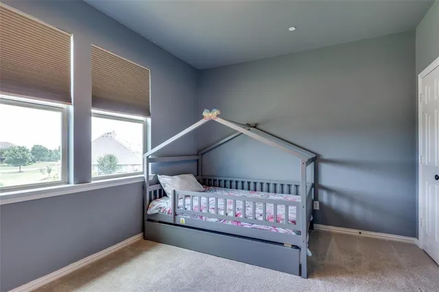 a wooden bench sitting in front of a window