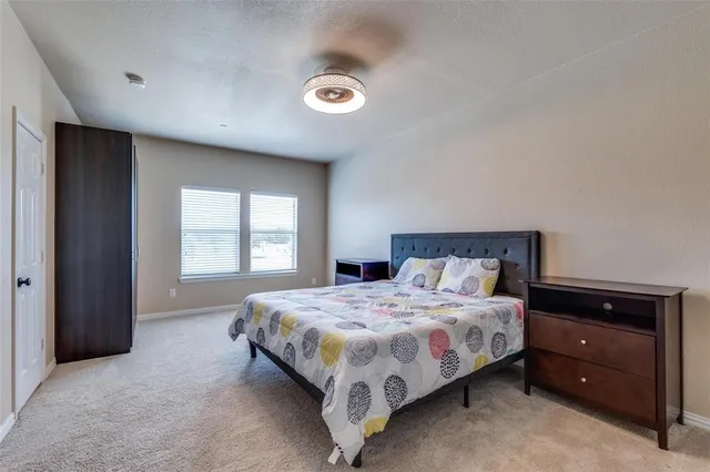 a bedroom with a bed and window