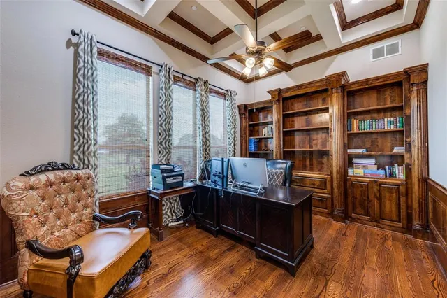 a view of a livingroom with workspace and a window