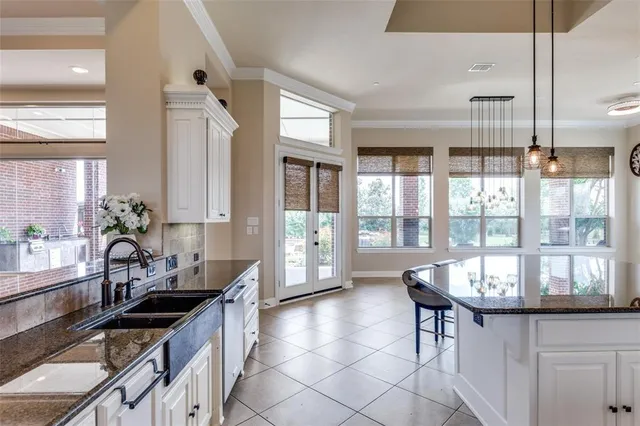 a kitchen with granite countertop a stove and a sink