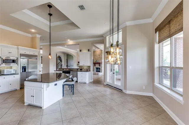 a view of a kitchen with kitchen island dining area and a large window