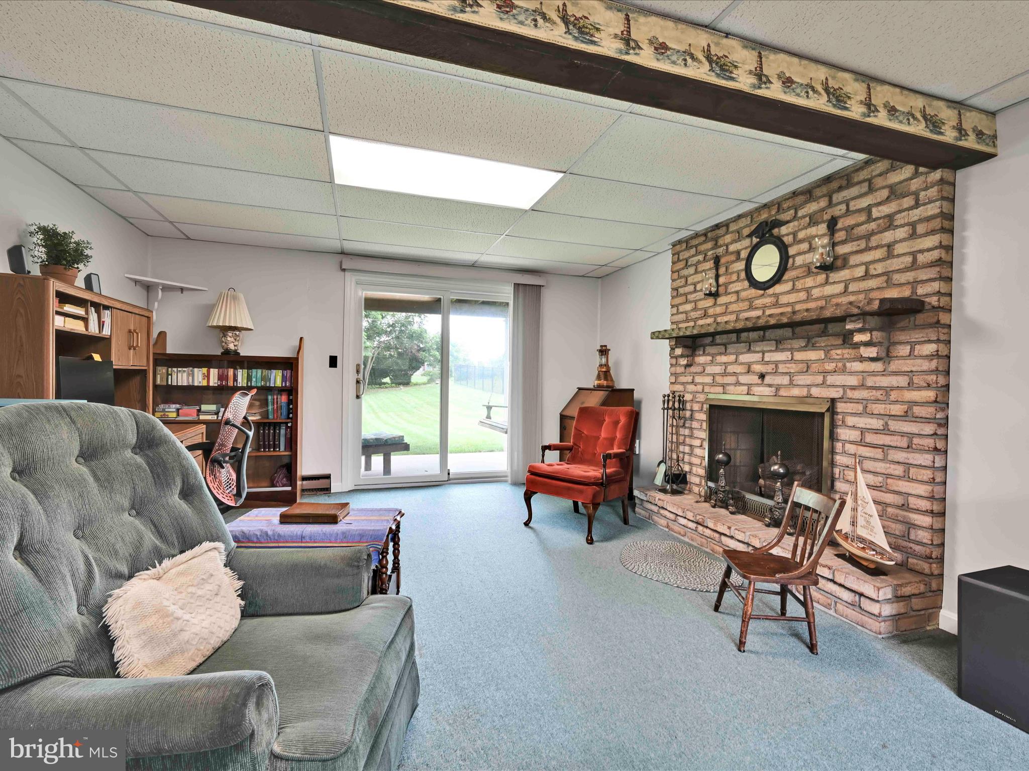 301 Owl Hill Road Lititz, PA 17543 - Photo 17 of 35 a living room with furniture a fireplace and a large window