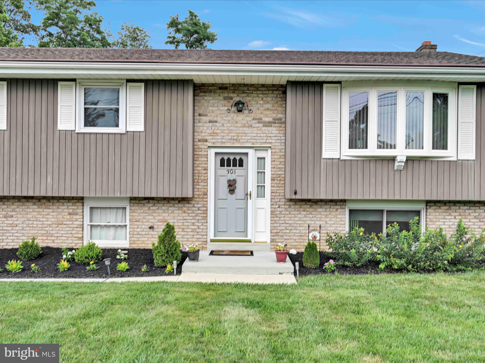 301 Owl Hill Road Lititz, PA 17543 - Photo 33 of 35 a front view of a house with a yard and potted plants