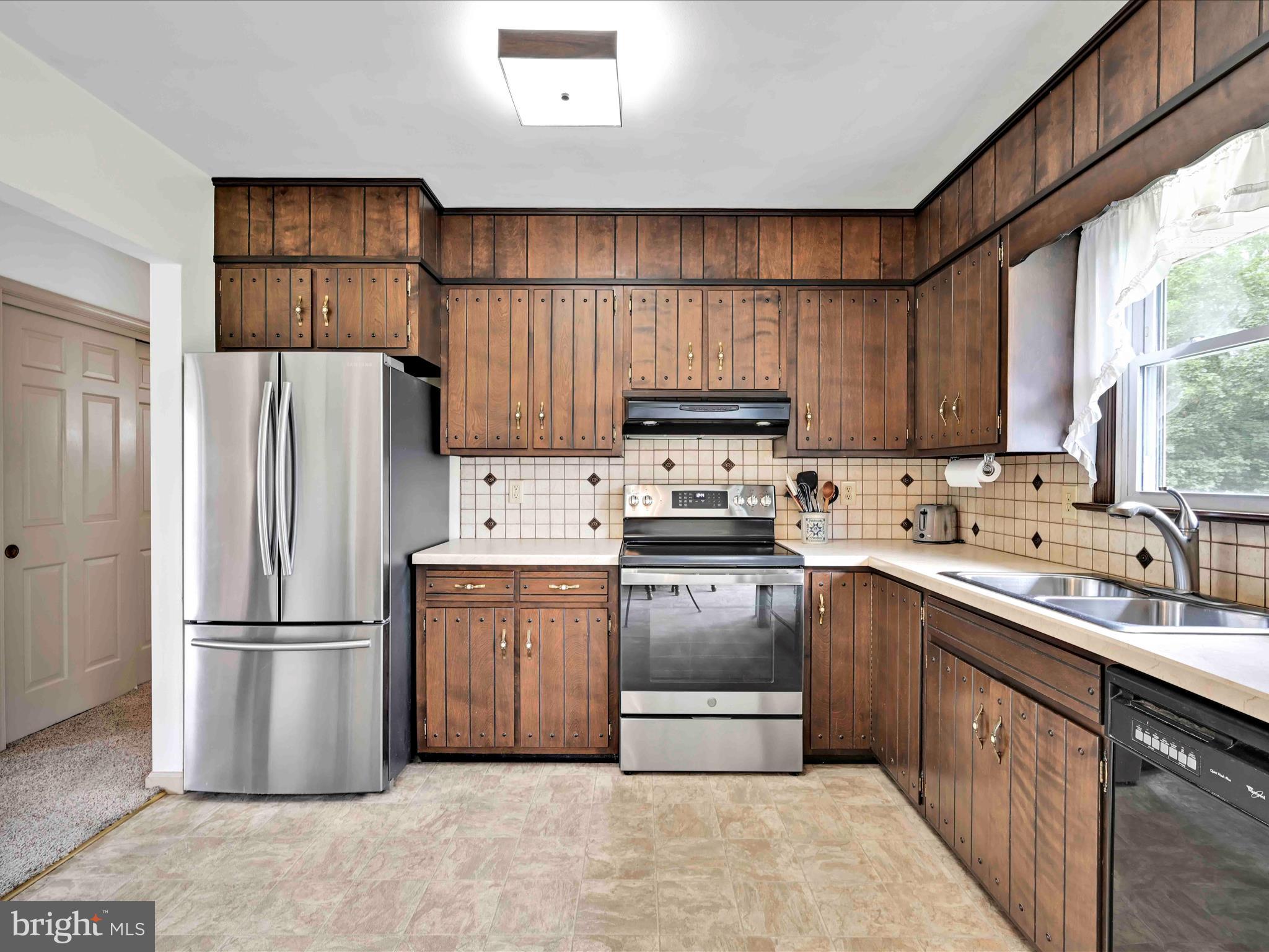 301 Owl Hill Road Lititz, PA 17543 - Photo 9 of 35 a kitchen with a refrigerator sink and wooden cabinets