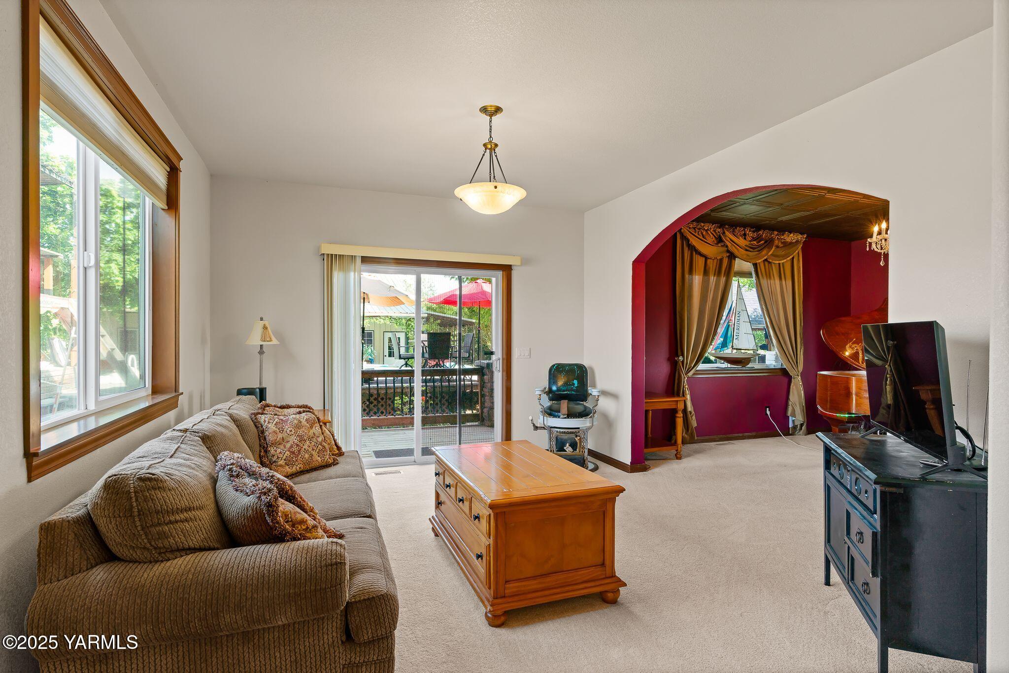 12900 Douglas Road Yakima, WA 98908 - Photo 15 of 62 a living room with furniture a window and a flat screen tv
