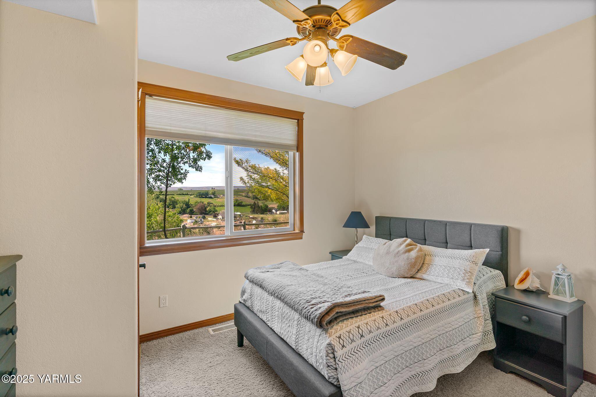 12900 Douglas Road Yakima, WA 98908 - Photo 35 of 62 a bedroom with a bed and a chandelier