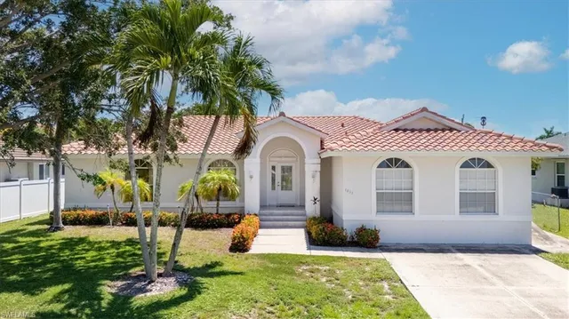 a front view of a house with garden