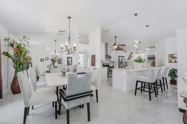 a dining room with furniture and a chandelier