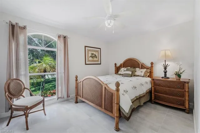 a bedroom with a bed chair and a window