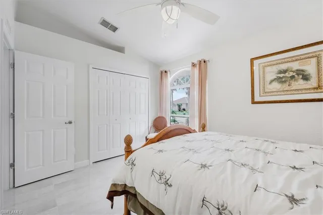a bedroom with a bed and a painting on the wall