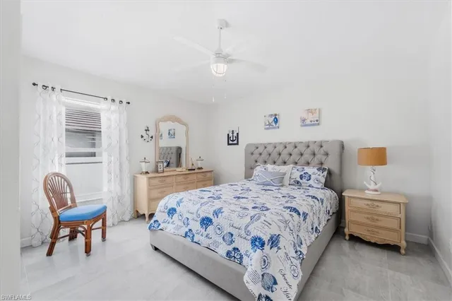 a bedroom with a bed and a chair in it